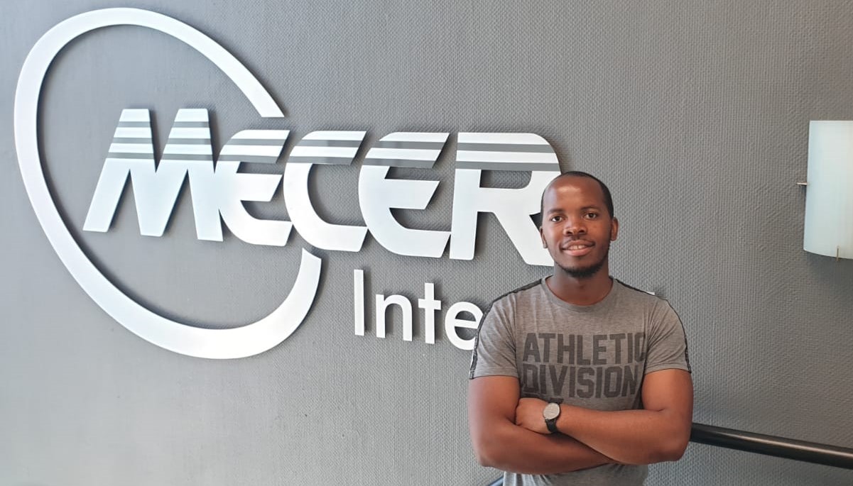 Standing in front of the Mecer Inter-Ed logo on my last day
